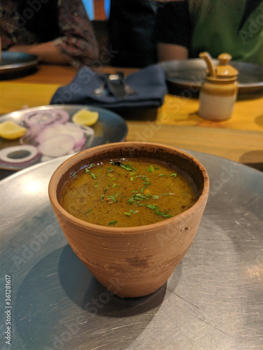Chicken Shorba or broth in a wooden Bowl