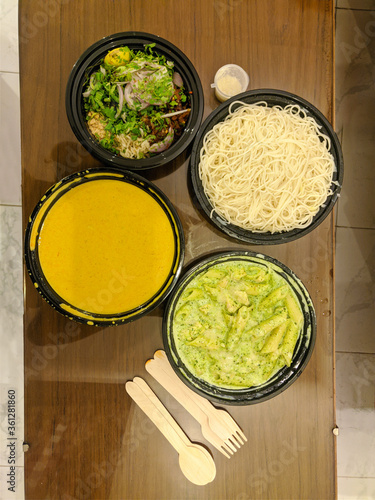 Khowsuey, Burmese cuisine. Noodle soup made of egg noodles and curried beef or chicken with coconut milk, served with a variety of contrasting condiments. photo