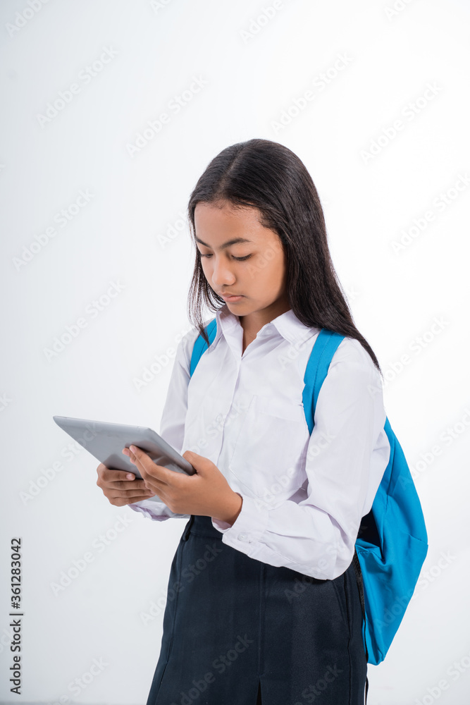 girl junior high school student using tablet pc over white background girl junior high school student using tablet pc over white background