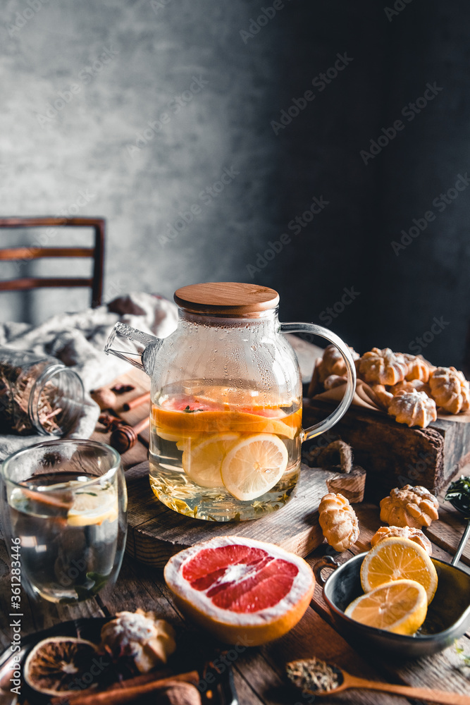 Hot tea with slices of fresh grapefruit on wooden tablet. Healthy drink, Eco, vegan Hot tea with slices of fresh grapefruit on wooden tablet. Healthy drink, Eco, vegan