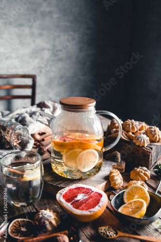 Fototapeta Naklejka Na Ścianę i Meble -  Hot tea with slices of fresh grapefruit on wooden tablet. Healthy drink, Eco, vegan