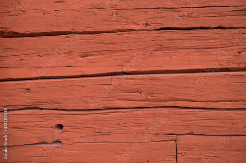Close up of a wooden cottage with deep Falu red or falun red paint. This is a dye that is used in a deep red paint, well known for its use on wooden cottages and barns in Sweden and Finland photo