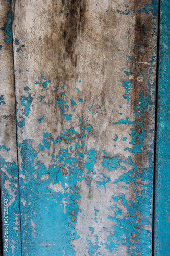 filled frame close up background wallpaper shot of an old ragged and scuffed blue turquoise painted wooden wall forming beautiful patterns and shapes © Liza