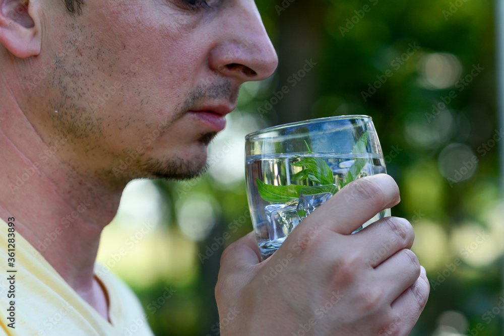 Close up of Man Drinking Fruit Water. Detox. Healthy Lifestyle And Food. Close up of Man Drinking Fruit Water. Detox. Healthy Lifestyle And Food.