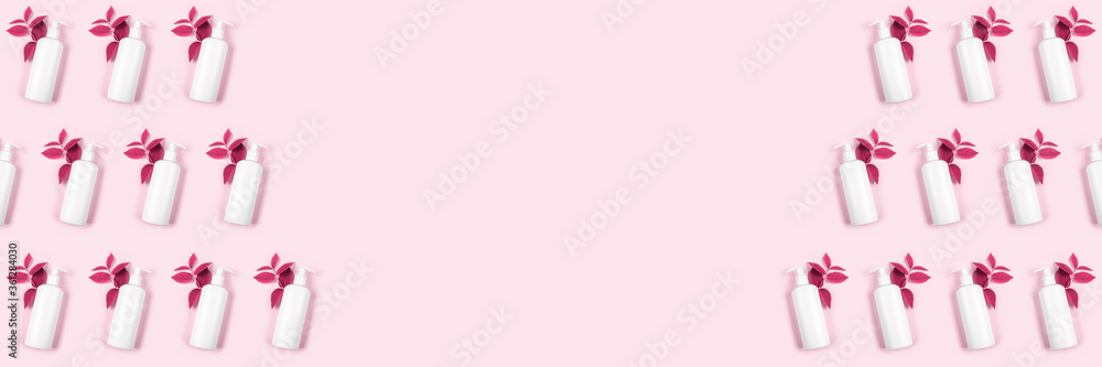 Products for women's intimate hygiene concept. White bottles of antiseptic to protect against germs on pastel pink background. Antibacterial pattern. Liquid soap. Place text. Copy space. Banner.