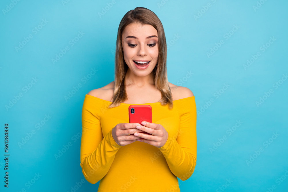 Close-up portrait of her she nice-looking attractive lovely charming cute glad cheerful cheery girl using device chatting web isolated over bright vivid shine vibrant blue color background Close-up portrait of her she nice-looking attractive lovely charming cute glad cheerful cheery girl using device chatting web isolated over bright vivid shine vibrant blue color background