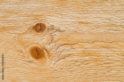 Planche de bois brut et nœuds.