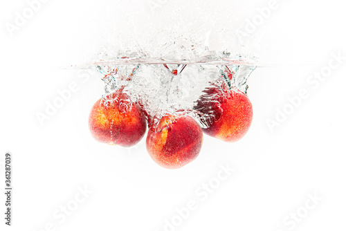 Fresh Nectarines with water splash against white background