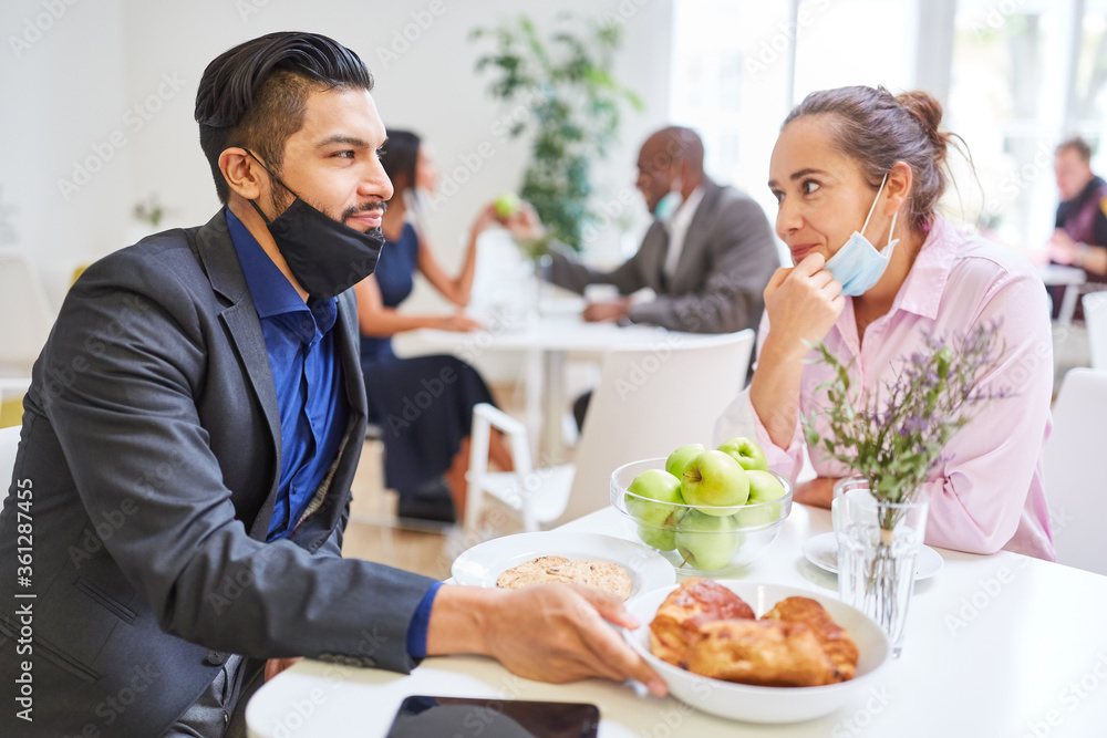 Two business people as a couple flirting in the cafeteria