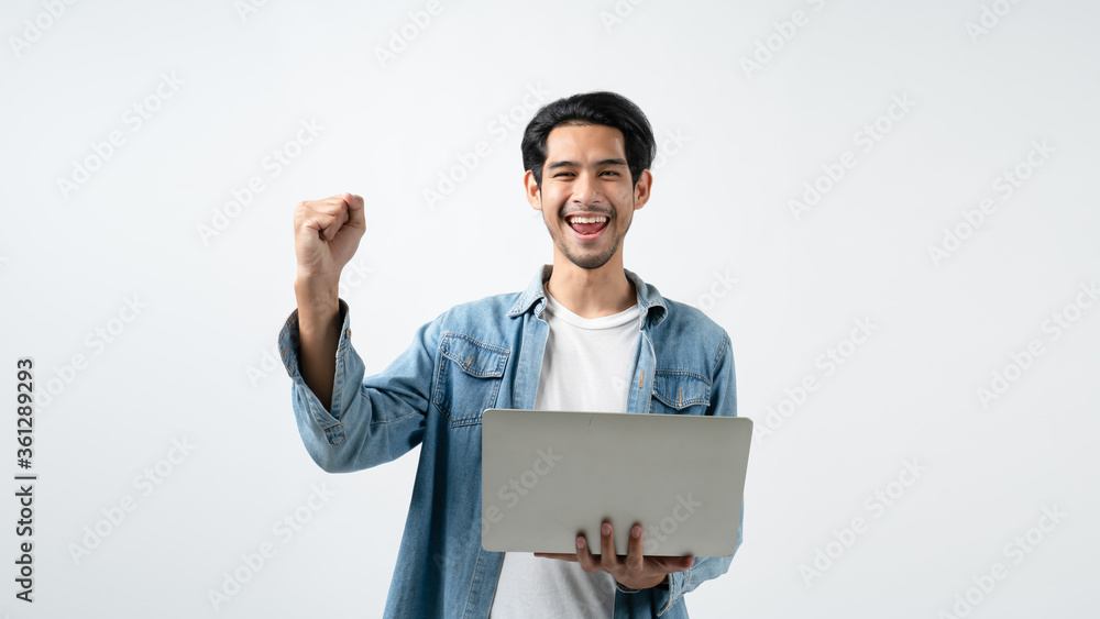 Network and business communication ideas concept with asian attractive male in jean coat and white shirt hand hold laptop smile and happiness hand gesture pose joyful moment in white background. Network and business communication ideas concept with asian attractive male in jean coat and white shirt hand hold laptop smile and happiness hand gesture pose joyful moment in white background.