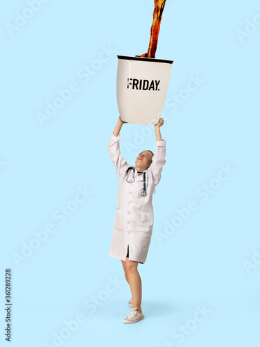 Gas up yourself, filling up with coffee to wake up. Creative artwork. Doctor or nurse holding huge cup with pouring coffee. Looks bored and tired, needs cistern of aroma drink to feel energy. photo