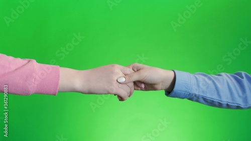 Friends shaking hands. Handshake wiht two hands, keyed green screen