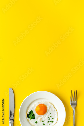 Fried eggs on plate - yellow desk top view space for text