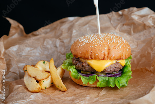 hamburger with fries on a wooden background