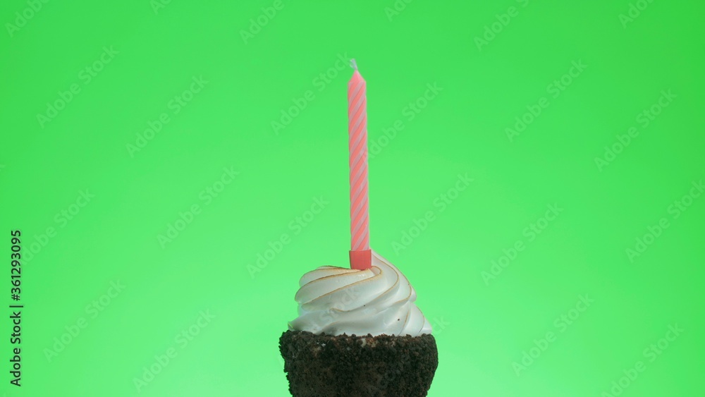 Lighting a blue candle on a delicious cupcake, green screen Lighting a blue candle on a delicious cupcake, green screen