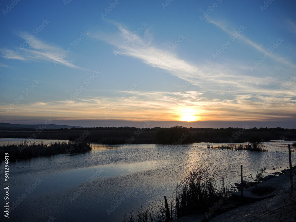Breathtaking sunset in Danube Delta, Romania, in a summer day; outdoors Breathtaking sunset in Danube Delta, Romania, in a summer day; outdoors
