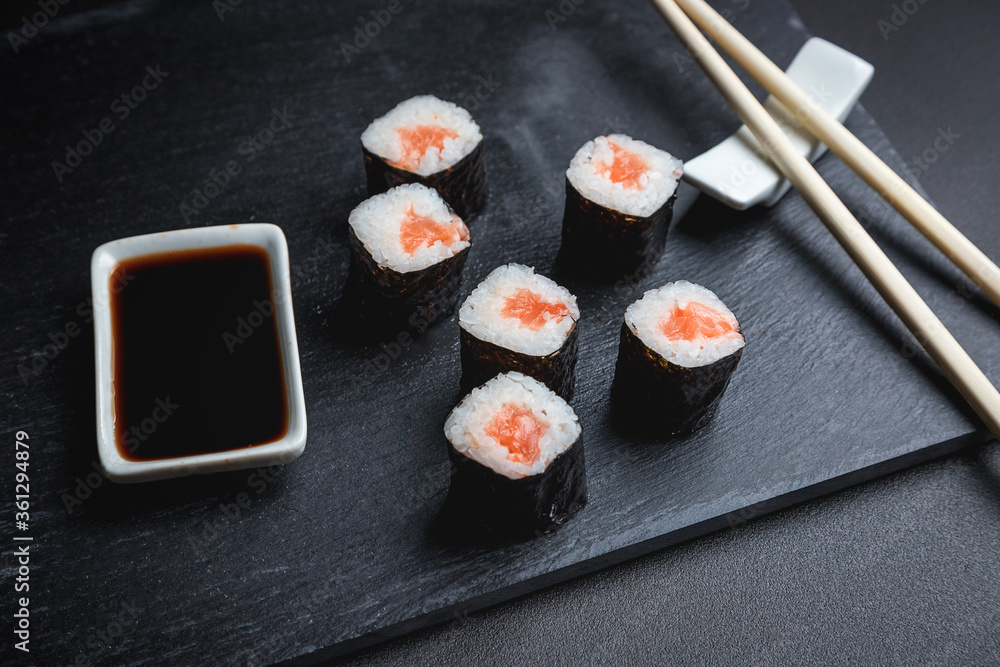 Sushi on a black background. Perfect for creating a sushi restaurant menu. Japanese cuisine, Eastern culture. Sushi on a black background. Perfect for creating a sushi restaurant menu. Japanese cuisine, Eastern culture.