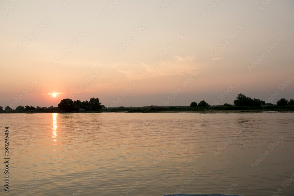 Breathtaking sunset in Danube Delta, Romania, in a summer day; outdoors Breathtaking sunset in Danube Delta, Romania, in a summer day; outdoors