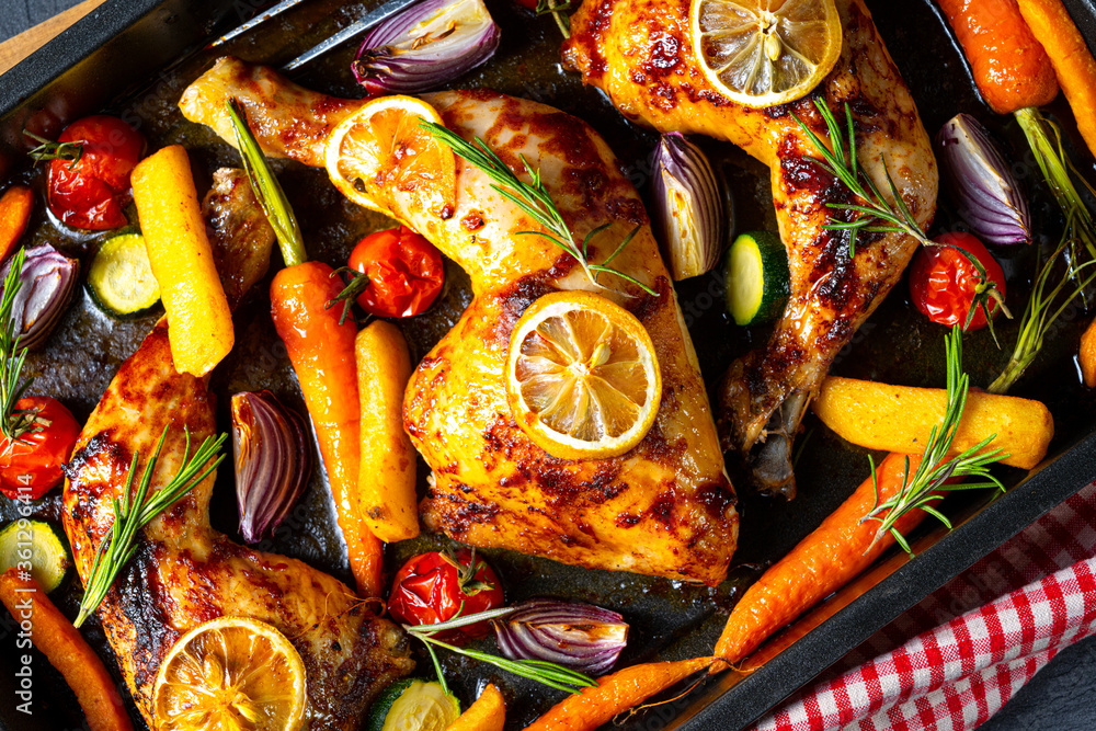 Grilled chicken legs with various vegetables and herbs.
