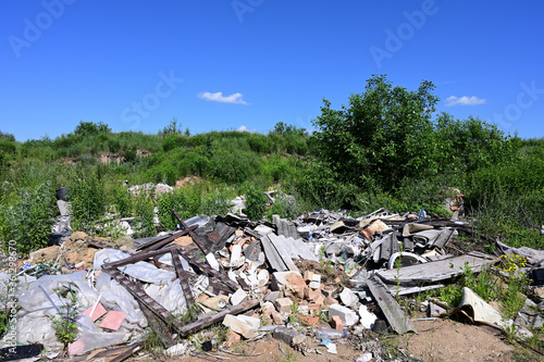 Photo with trash outdoors on a sunny summer day against a cloudless sky