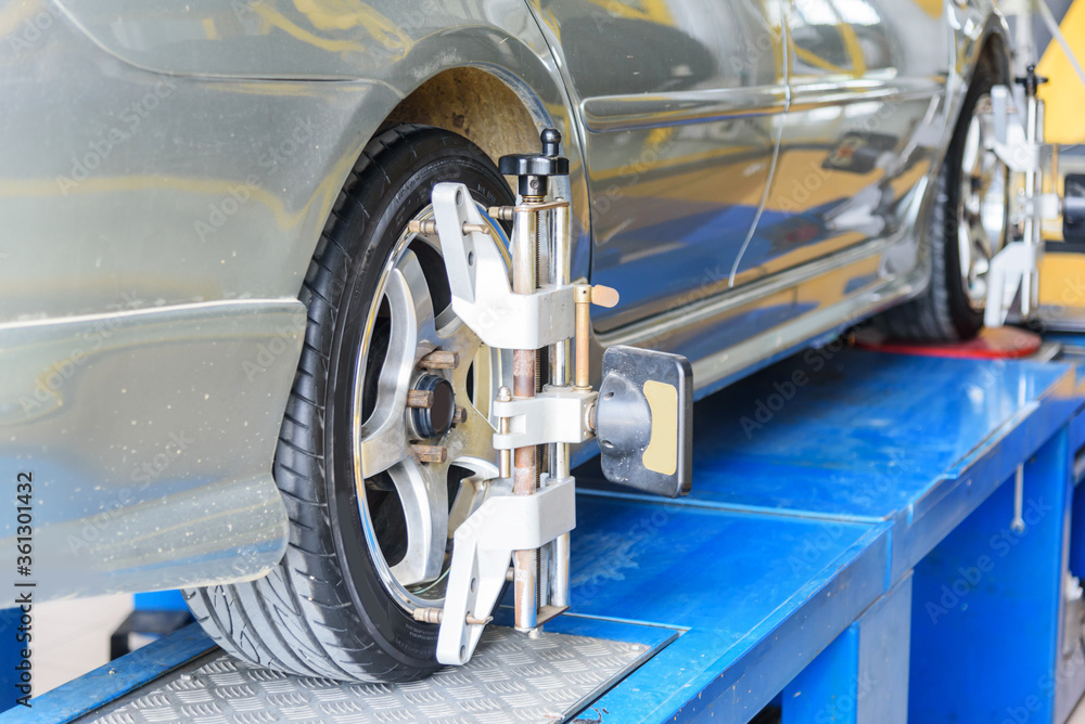 Fototapeta premium Car Wheel Alignment in tire garage service 