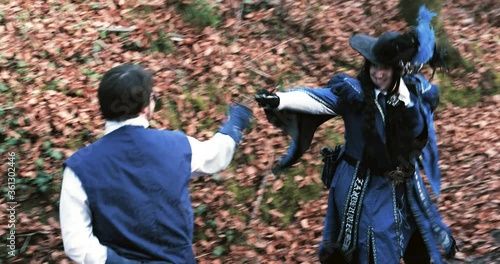 Musketeers fencing in forest photo