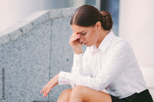 Portrait stressed young depressed business woman in suit feel headache due to work failure. Disappointed frustrated sad girl entrepreneur feel exhausted. Worried upset girl student failed exam test © Artem