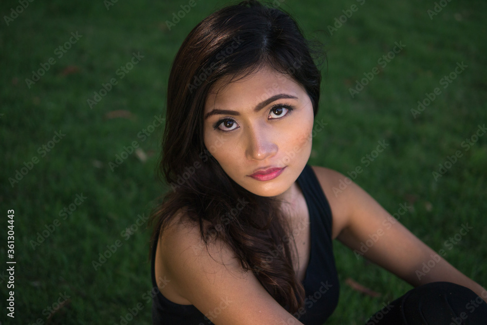 Young beautiful Asian woman at the park outdoors Young beautiful Asian woman at the park outdoors
