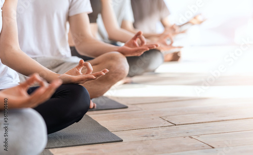 Zen And Meditation. Group Of People Meditating Together In Lotus Position, Cropped