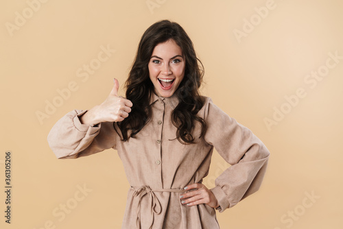 Image of excited caucasian woman smiling and showing thumb up