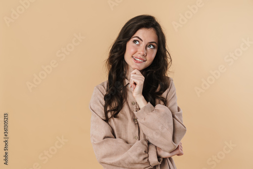 Image of pleased caucasian woman dreaming and looking upward