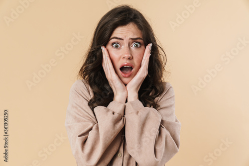 Tableau sur toile Image of scared shocked nice woman posing and looking at camera