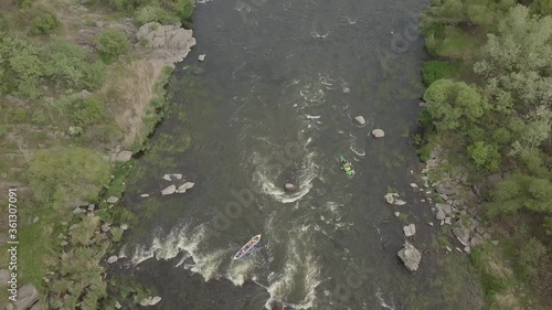 Aerial view to granite mountains and rapids on Southern Bug river with kayak and tourist on it , Mihiia village. Ukraine. Famous place for rafting and kayaking photo