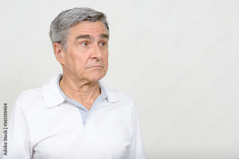 Portrait of handsome senior man thinking and looking away Portrait of handsome senior man thinking and looking away
