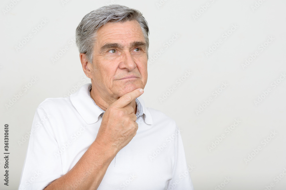 Portrait of handsome senior man thinking and looking up Portrait of handsome senior man thinking and looking up