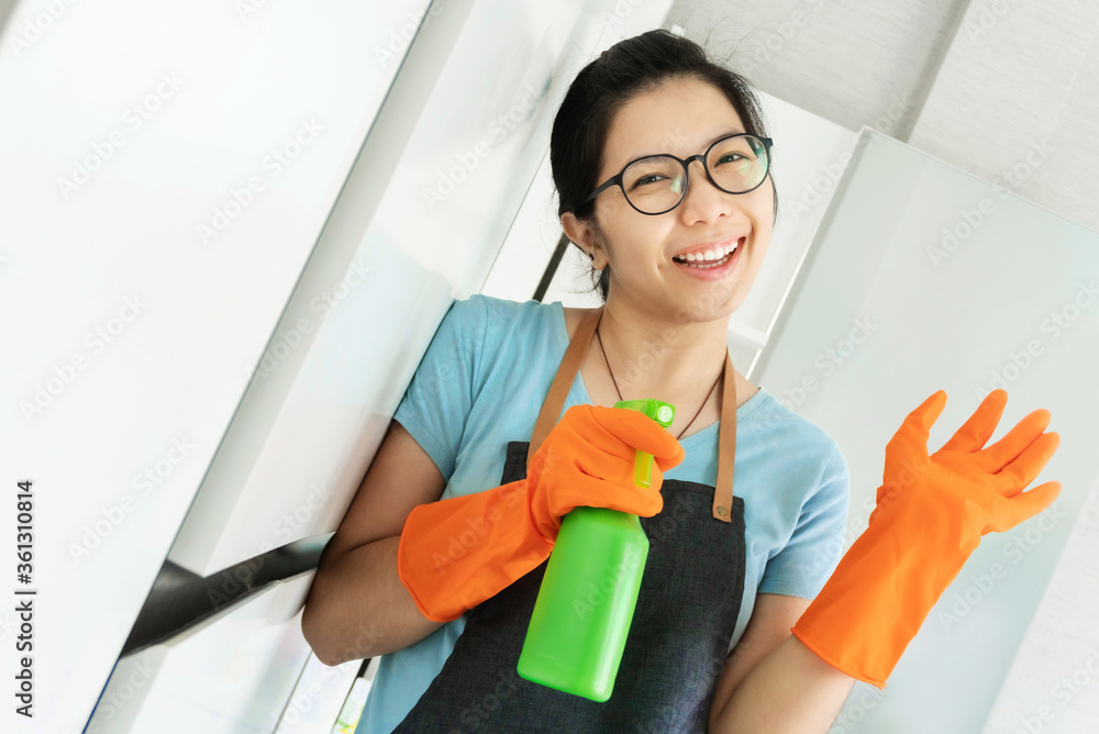Smiling Asian Young girl in eyeglasses preparing cleaning house. Smiling Asian Young girl in eyeglasses preparing cleaning house.