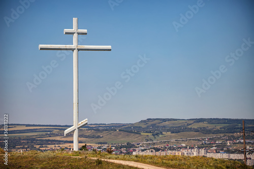 A large metal cross of worship stands on a hill at the site of the founding of the Cossack village