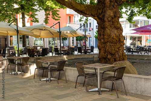 Outdoor cafe. Tables under the tree. Restaurant in Germany. Hessian city.