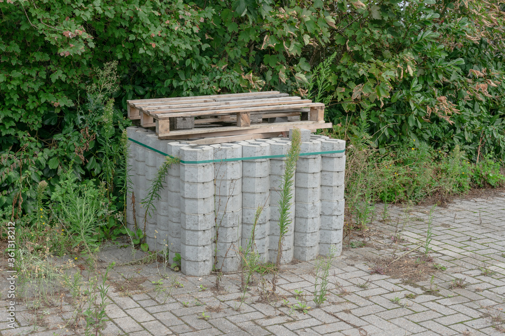 stack of hexagonal concrete bricks with wooden pallets on them stack of hexagonal concrete bricks with wooden pallets on them