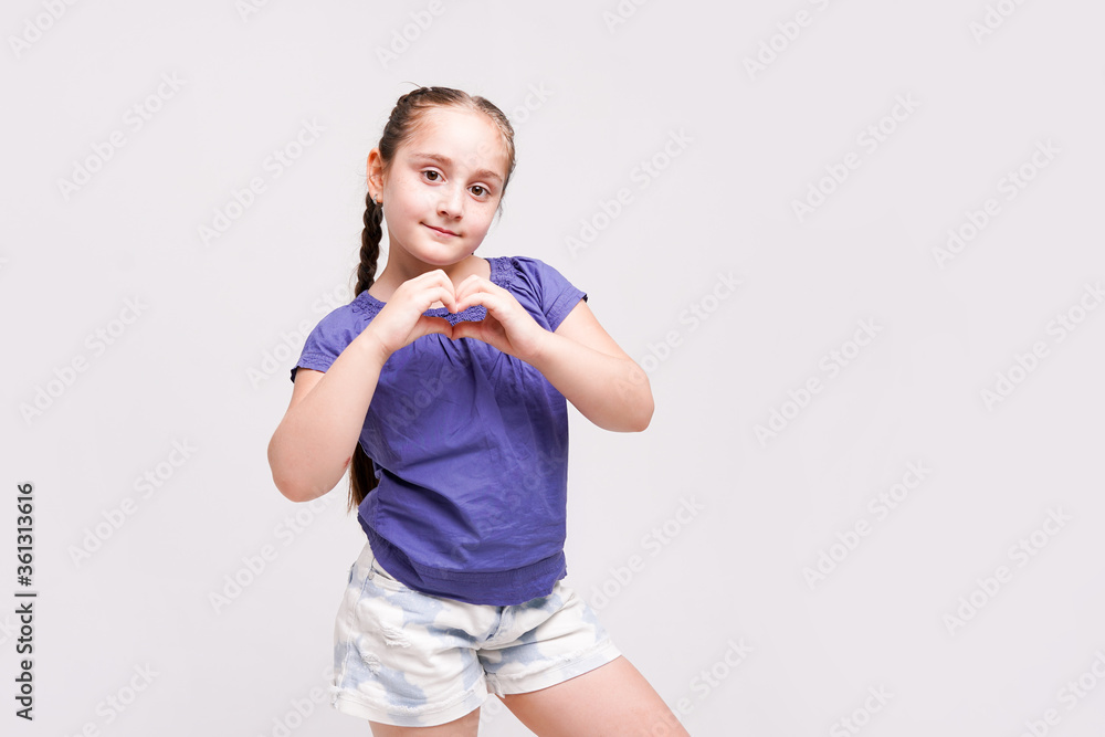 Little girl shows heart with her hands on white background Little girl shows heart with her hands on white background