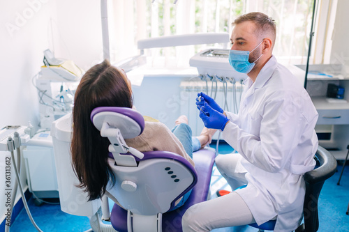 female sits in dentist chair and undergo dentist examining. dent