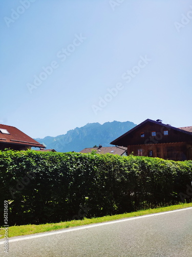 view of idyllic mountain scenery in the Alps on a sunny day with houses and blue sky in summer photo