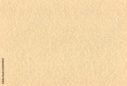 Sheet of textured pale brown coloured recycled creative paper background. Extra large highly detailed image.