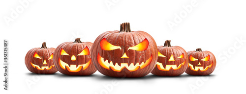 A group of five lit spooky halloween pumpkins, Jack O Lantern with evil face and eyes isolated against a white background.