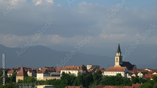 Wallpaper Mural Time lapse of Church tower and old buildings in old town Kranj, Slovenia. Alps mountains in the distance Torontodigital.ca