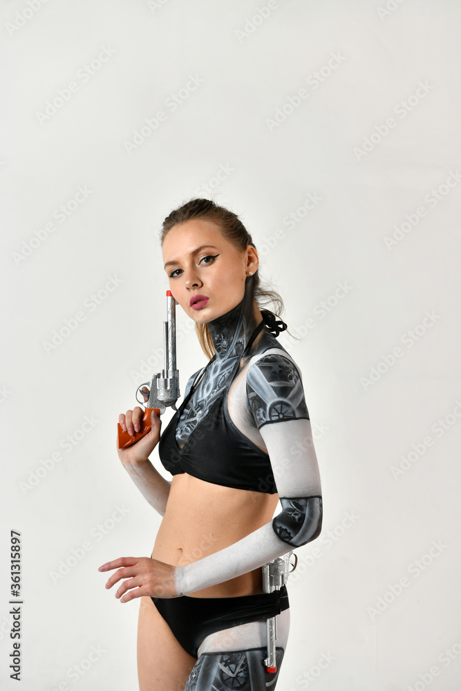 beautiful girl in a robot suit makes fighting movements with silver revolvers on a white background beautiful girl in a robot suit makes fighting movements with silver revolvers on a white background
