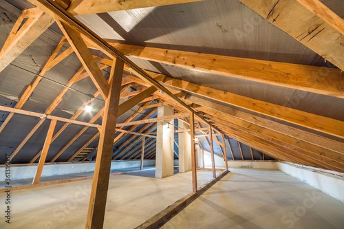 Attic of a building with wooden beams of a roof structure.