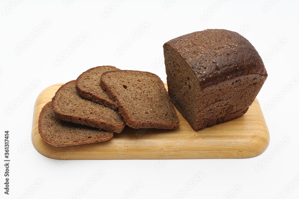 Rye bread on wooden cutting board on a white background Rye bread on wooden cutting board on a white background