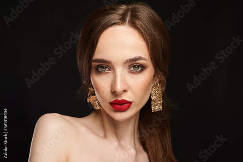 High Fashion Model Girl Portrait with Trendy Hair style and Makeup. Long Black Hairstyle, Black Hair and Red Matte Lipstick. Woman Makeup. Sexy Lips. Haircut