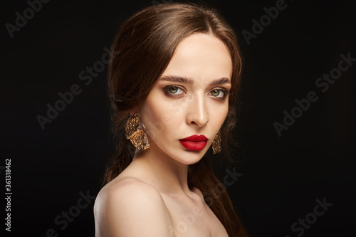 High Fashion Model Girl Portrait with Trendy Hair style and Makeup. Long Black Hairstyle, Black Hair and Red Matte Lipstick. Woman Makeup. Sexy Lips. Haircut